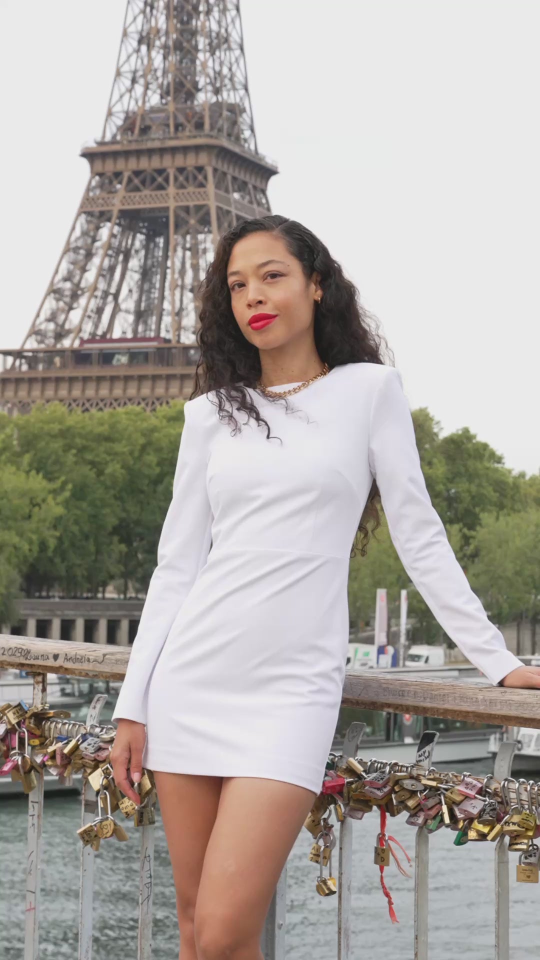 Model wearing the Michèle white tailored mini dress by Leochèle with the Eiffel Tower in Paris in the background.