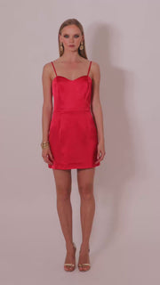 Model wearing the Gohar red satin mini dress by Leochèle turns and walks out of frame