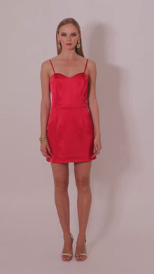 Model wearing the Gohar red satin mini dress by Leochèle turns and walks out of frame