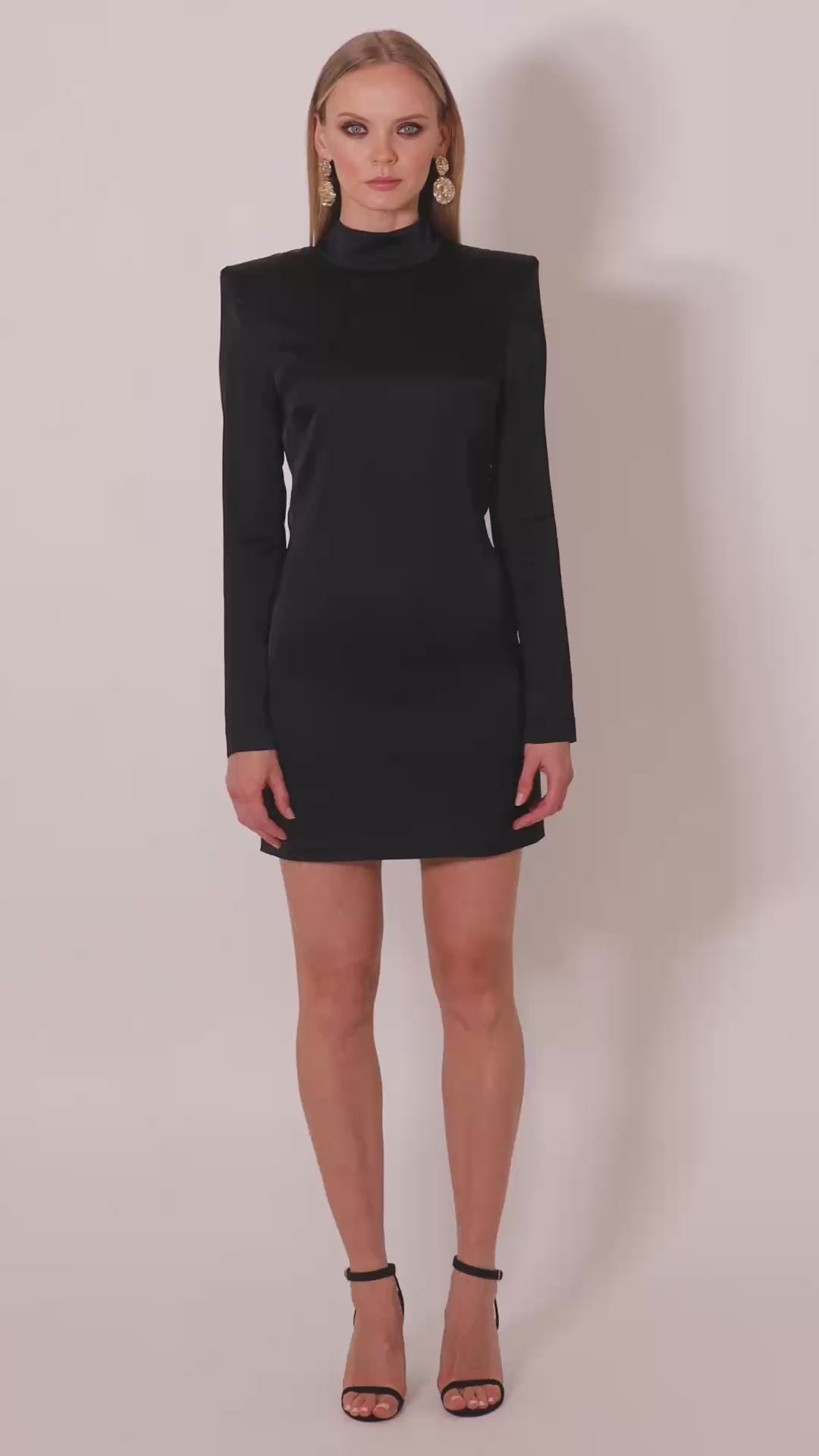 Model wearing the Valentina satin mini dress by Leochèle turns and walks out of frame