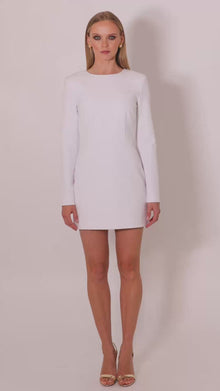 Model wearing the Michèle tailored mini dress by Leochèle turns and walks out of frame